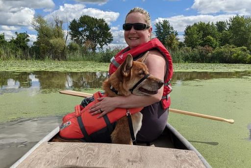 woman sitting in canoe with dog | The Kas Pack